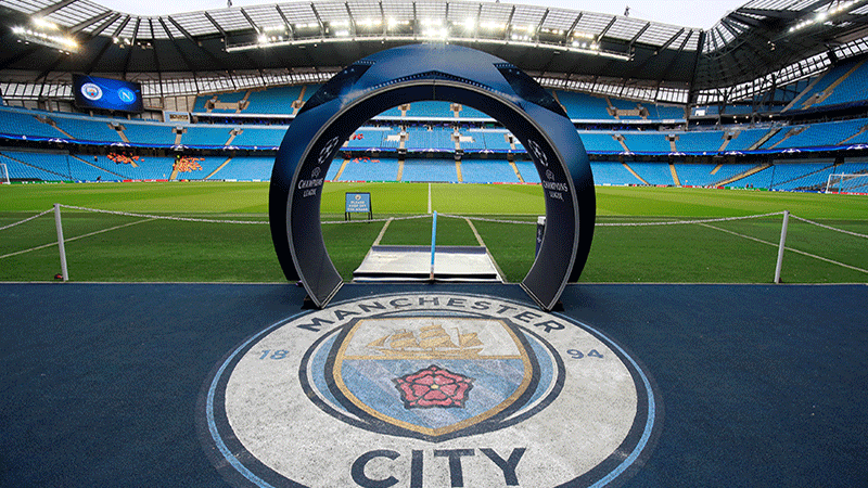 City of Manchester Stadium med Champions League ingng med Manchester City emblem och bla lktare. Vlj fotbollsresor och fotbollsbiljetter till Manchester City matcher i Premier League i England.